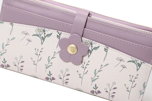 Close-up of floral buckle and mixed purple leather texture on long wallet