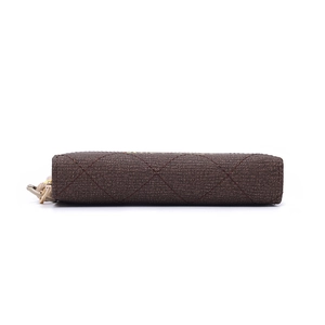 Detailed side view of a brown quilted lattice wallet with a premium golden zipper puller