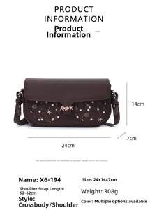 Detail view of floral crossbody bag with dimensions 24x14x7cm and metal leaf lock