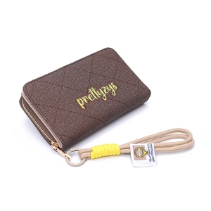 Detail of dark brown quilted PU leather wallet featuring yellow embroidery and wrist strap