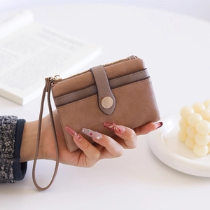 Close-up of a two-tone PU leather wallet with a zipper pocket and snap-button card slot