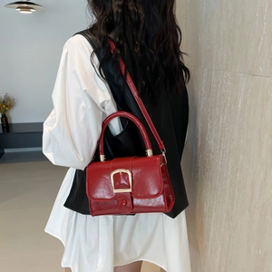 Glossy red patent leather square handbag with gold buckle in street fashion style