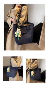 Detail of dark blue denim tote bag with white contrast stitching and plush dog charm