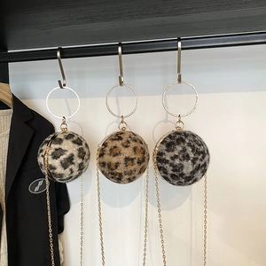Leopard print sphere handbag with gold ring handle and chain strap in various tones