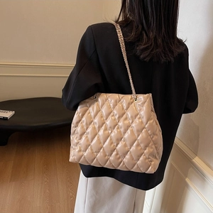 Beige quilted chain shoulder bag with elegant diamond stitching and crossbody strap