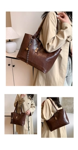 Detail of dark brown leather tote bag with metallic lock and braided bell pendant charm