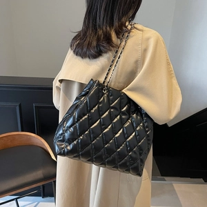 Classic black quilted leather tote bag with stylish chain strap for women outfit