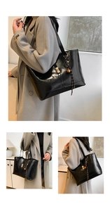 Detail of glossy black quilted tote bag with gold buckle and brown woven pendant