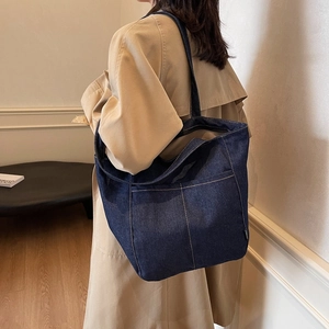 Large denim tote bag with contrast stitching and shoulder strap for casual daily use