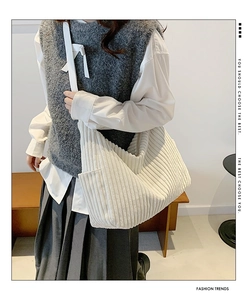 White corduroy hobo bag on model showing large capacity and soft ribbed texture detail