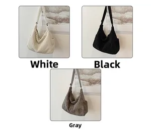 Detail view of corduroy shoulder bags in white, black and grey with adjustable straps
