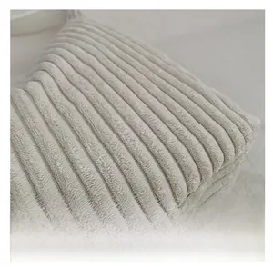 Macro detail of high-quality corduroy fabric showing soft cream vertical ribbed texture