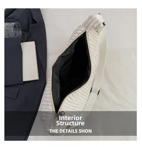Interior view of white corduroy tote bag showing black lining and inner pocket detail