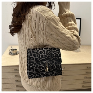 Detail of leopard print flap bag featuring a vintage gold-tone arch swivel metal clasp