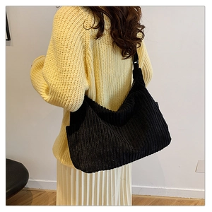 Detail shot of black corduroy tote bag showing soft ribbed texture and large capacity