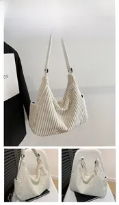 Detail of white corduroy tote bag showing side pocket and striped fabric texture