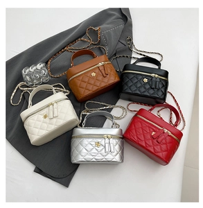 Detailed view of quilted bucket bags in five colors with metal chain and gold flower detail