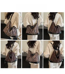 Detail of leopard print tote bag featuring leather base and stylish drawstring closure
