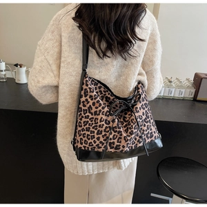 Detail shot of leopard print shoulder bag with black leather trim and chic bow decoration