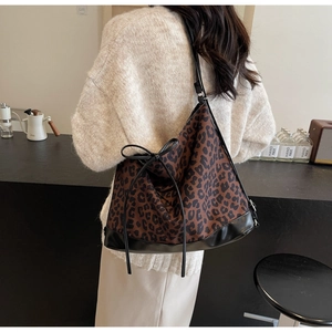 Detail of leopard print tote bag with black leather bow and large capacity design