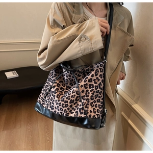 Leopard print canvas tote bag with black leather base and drawstring bow detail