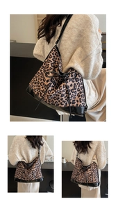 Detail of leopard print tote bag with black leather straps and a decorative bow