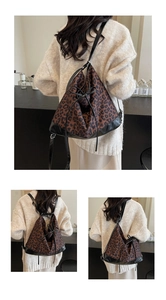 Detail of leopard print backpack with drawstring closure and black leather trim