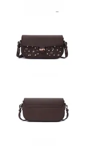 Front and back views of a dark brown crossbody bag with star-patterned pockets