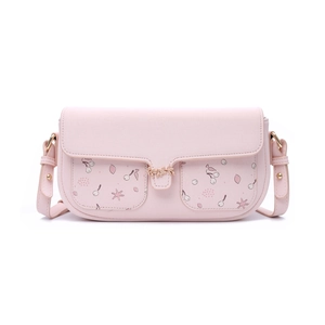 Detailed view of pink leather crossbody bag with leaf buckle and floral pockets
