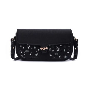 Detail of black crossbody bag featuring floral print pockets and golden leaf buckle