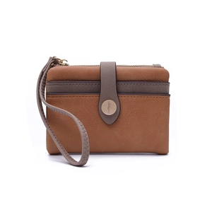 Detail of bifold brown PU leather wallet with gray wristlet and metal magnetic closure