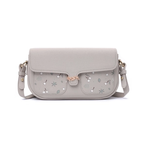 Detail of light gray crossbody bag with cherry prints and golden leaf metal clasp