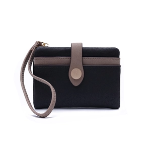 Close-up of a two-tone leather wallet featuring black litchi grain and taupe decorative strap