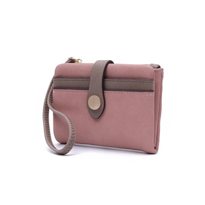 Detail view of pink PU leather wallet with metallic magnetic clasp and side zipper pocket