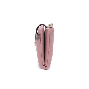 Detailed side view of vintage dusty pink bifold wallet showing stitching and multi-layers