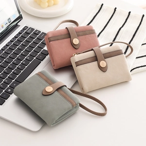 Detailed view of mini foldable PU leather wallets in soft Morandi colors with snap closures