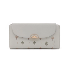 Detail of trifold floral wallet featuring botanical prints and gold metal clasp