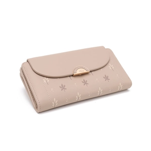 Detail of soft pink leather wallet featuring elegant leaf prints and a gold metal buckle