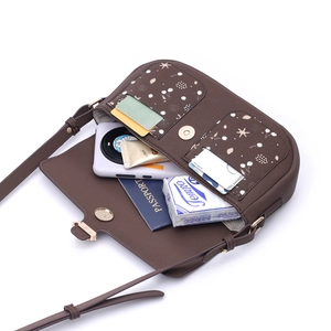 Deep brown patterned crossbody bag showing spacious interior with passport and phone