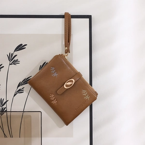 Brown PU leather wallet featuring botanical leaf embroidery and a metallic leaf logo