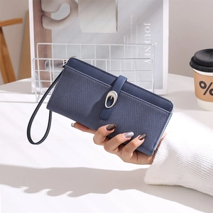 Detail of navy blue striped long wallet with metal buckle and leather wrist strap