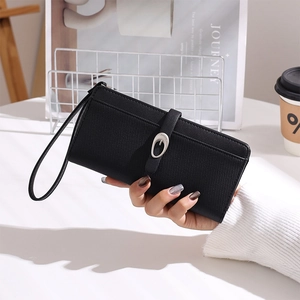 Detailed view of black cross-grain leather long wallet with silver buckle and wrist strap