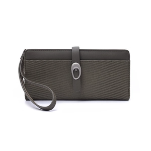Detail of long green wallet featuring striped texture, wrist strap, and metal buckle