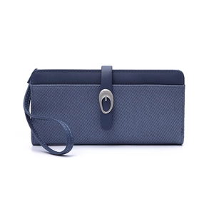 Detail of blue leather and striped fabric long wallet with metallic oval buckle clasp