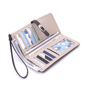 Interior detail of a women's long beige wallet with multiple card slots and wrist strap