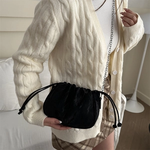 Elegant black velvet pleated chain cloud bag with classic embossed monogram pattern