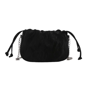 Chic black drawstring bucket bag with textured leather and silver chain strap