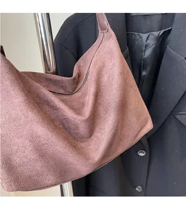 Close-up of frosted suede material and zipper closure on retro pink hobo shoulder bag