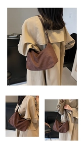 Detail of dark brown matte hobo bag worn by model with adjustable shoulder strap