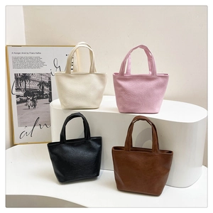 Group view of four minimalist soft leather mini tote bags in various neutral colors